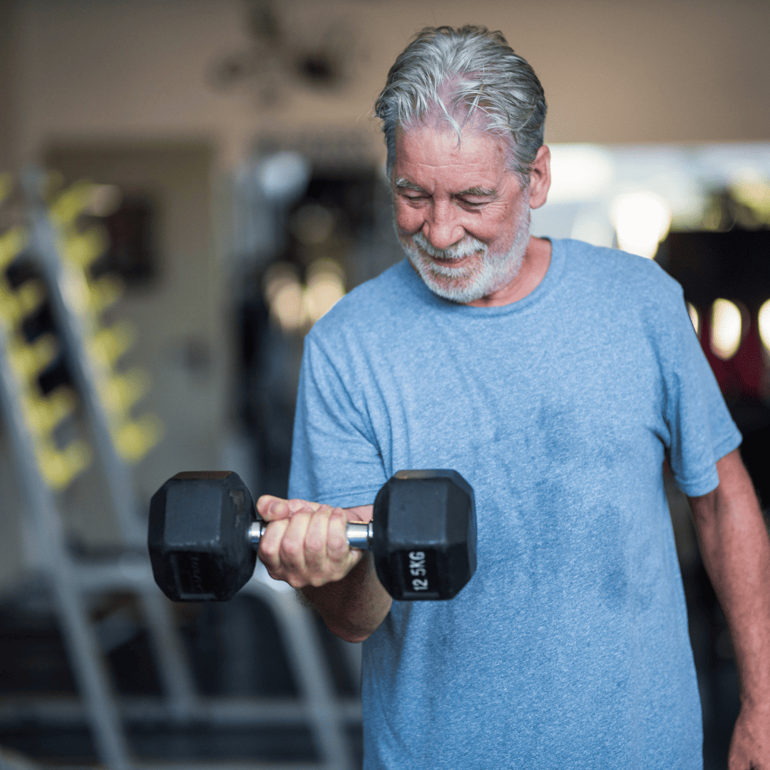 An elderly man manages his weight by completing regular weight training exercises